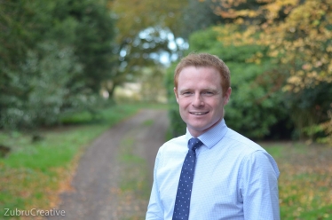 Photograph of newly selected Parliamentary Candidate for Keighley, Robbie Moore (standing in front of an avenue of trees